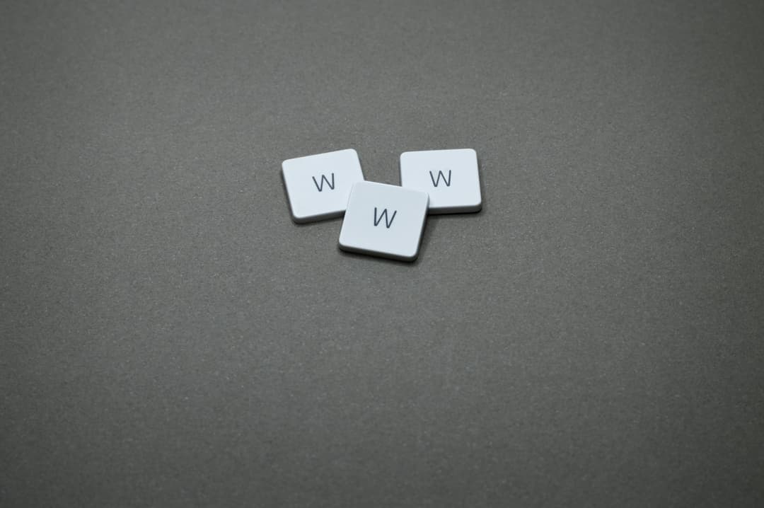 Prowall Free Wallpaper | Three white letter tiles with 'W' on a gray surface, minimalist design
