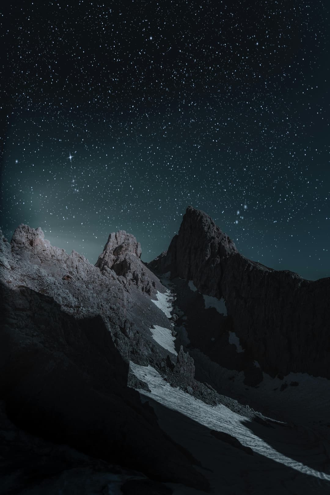 Prowall Free Wallpaper | Breathtaking view of a rocky mountain peak under a starry night sky, perfect for wallpapers.