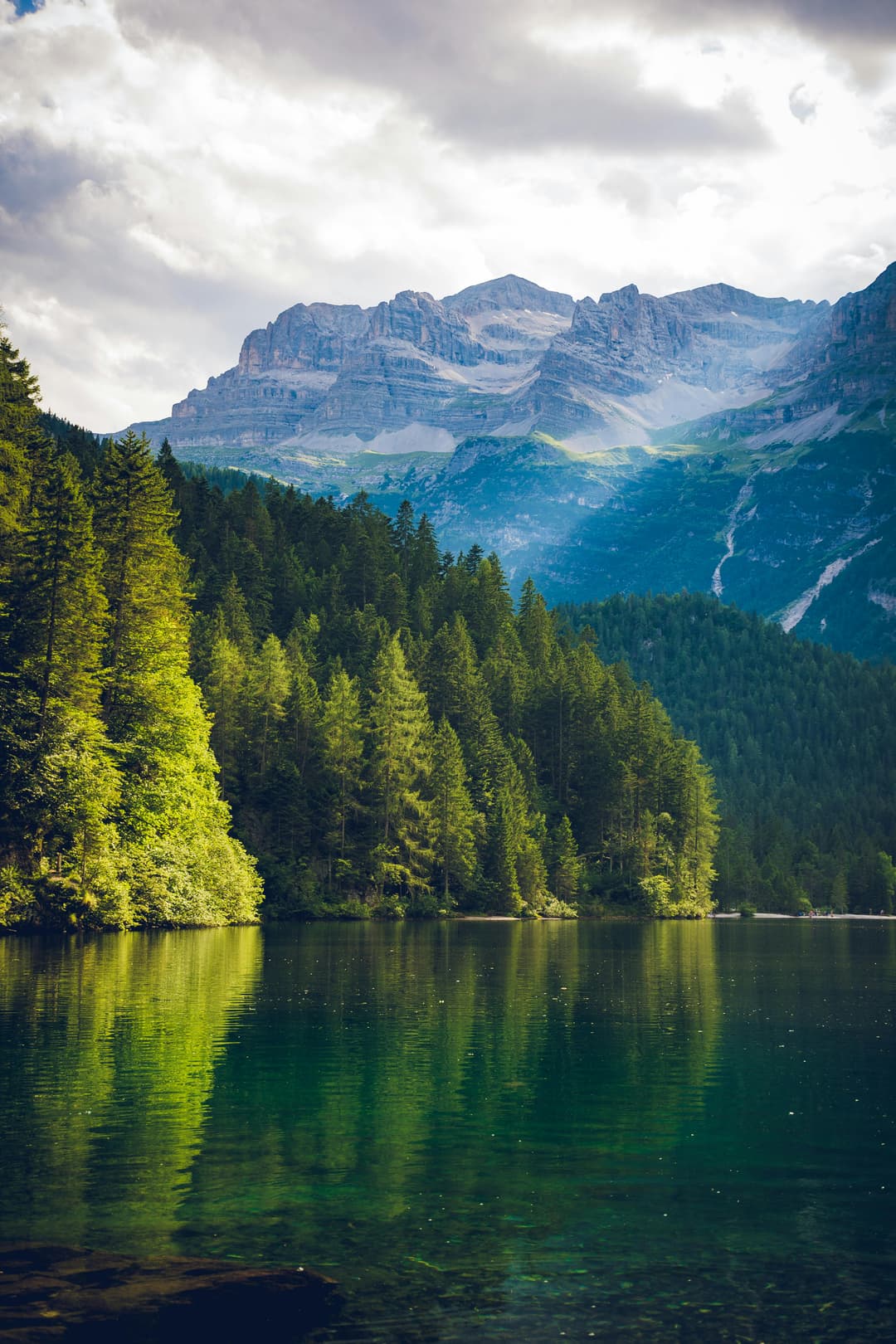Prowall Free Wallpaper | Peaceful alpine landscape featuring a serene lake with mountain and forest reflections.