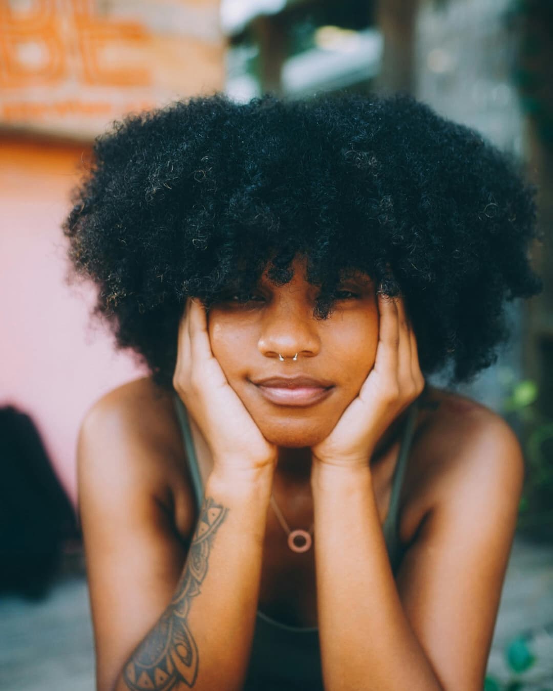 Prowall Free Wallpaper | Stylish woman with afro hairstyle and nose piercing in Atlanta outdoor setting.