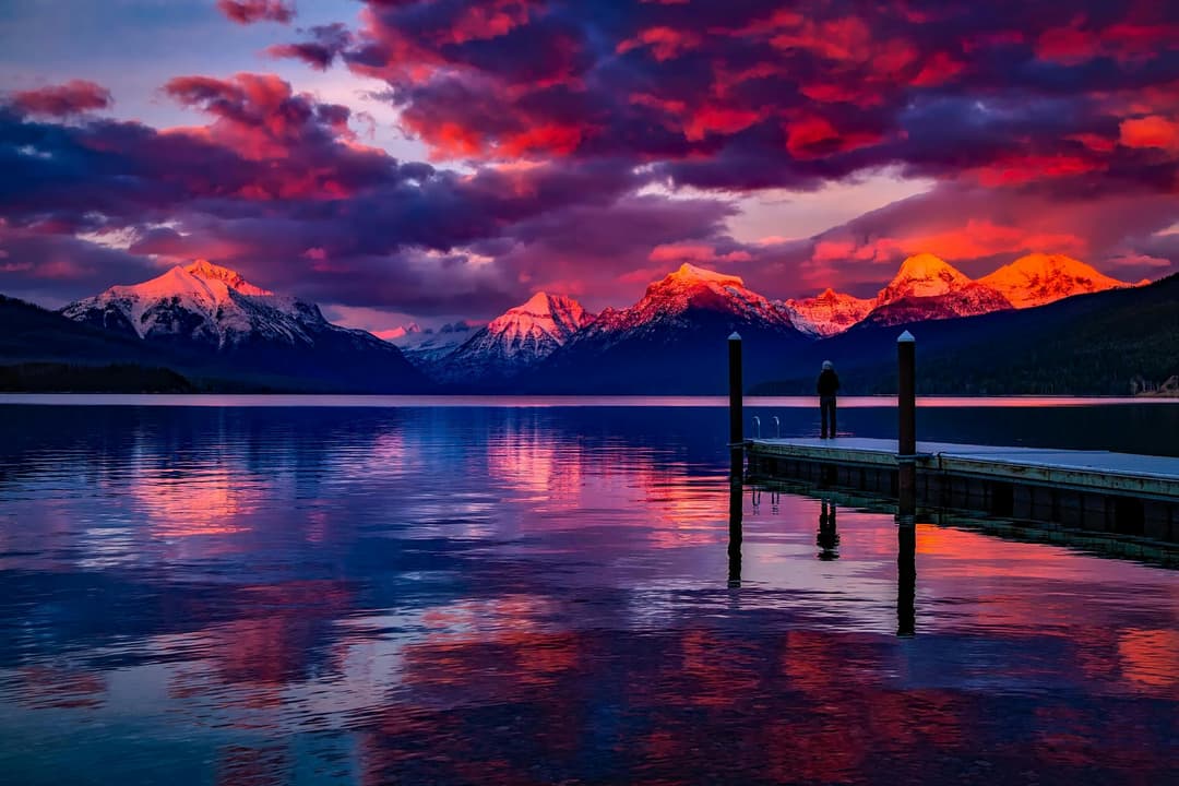 Prowall Free Wallpaper | Stunning sunset over a serene lake with colorful sky and majestic mountains.
