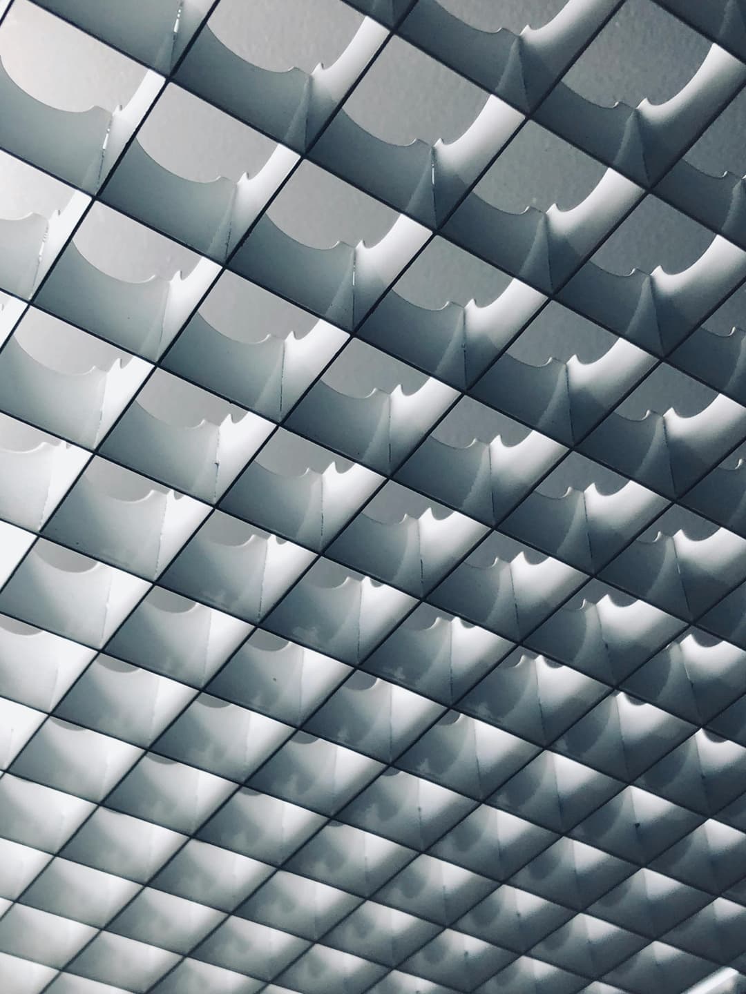 Prowall Free Wallpaper | Abstract metallic ceiling design with geometric patterns creating a modern and futuristic look.