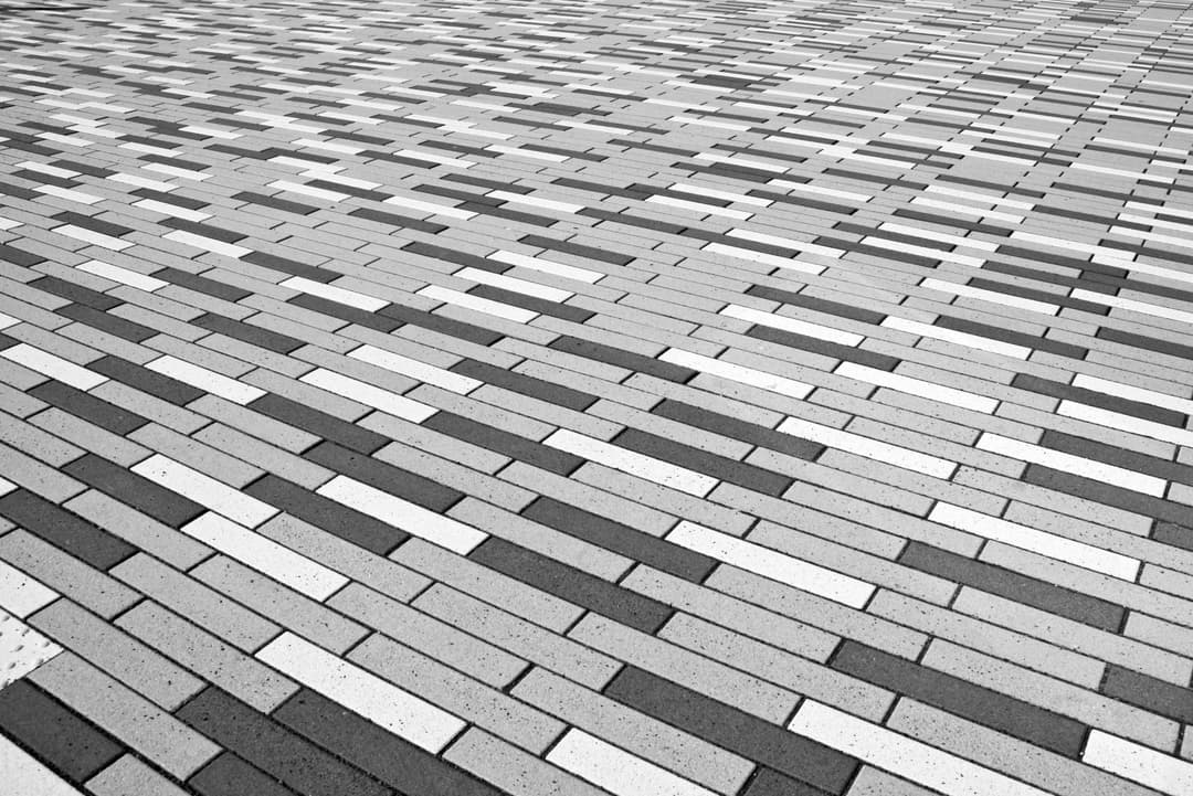 Prowall Free Wallpaper | Abstract black and white patterned brick floor provides a geometric visual effect.