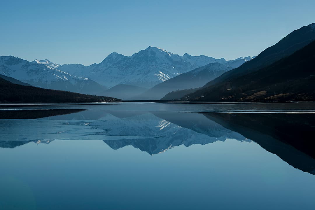 Prowall Free Wallpaper | Peaceful mountain landscape with clear reflections in a calm lake.
