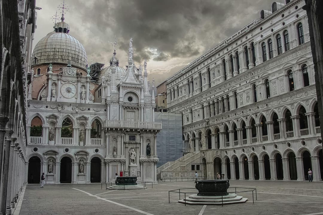 Prowall Free Wallpaper | Explore the architectural grandeur of Doge's Palace courtyard in Venice under dramatic skies.