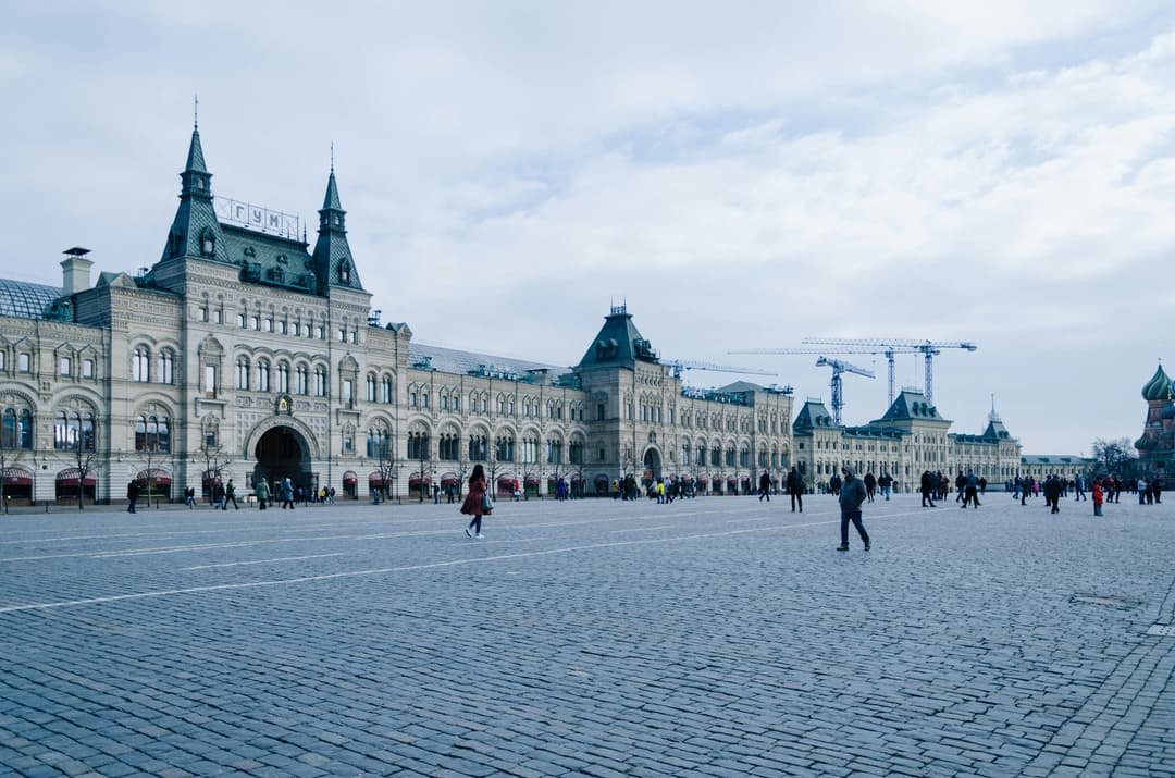 Prowall Free Wallpaper | Historic GUM department store facade at Red Square under a cloudy sky, Moscow, Russia.