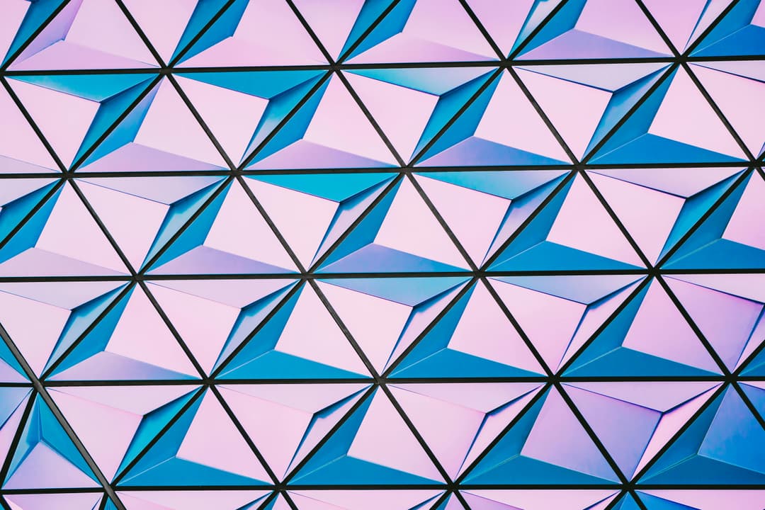 Prowall Free Wallpaper | A vibrant triangular pattern with shades of pink and blue for modern backgrounds.