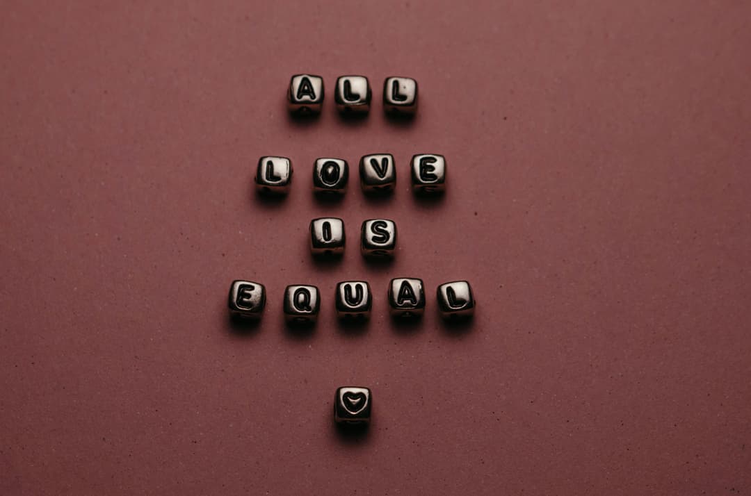 Prowall Free Wallpaper | Metallic letter blocks spell 'All Love is Equal' creating a message about equality.
