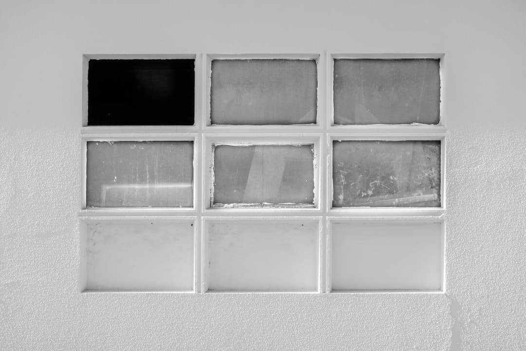 Prowall Free Wallpaper | Explore the textures and geometric patterns of a nine-panel minimalist window design.